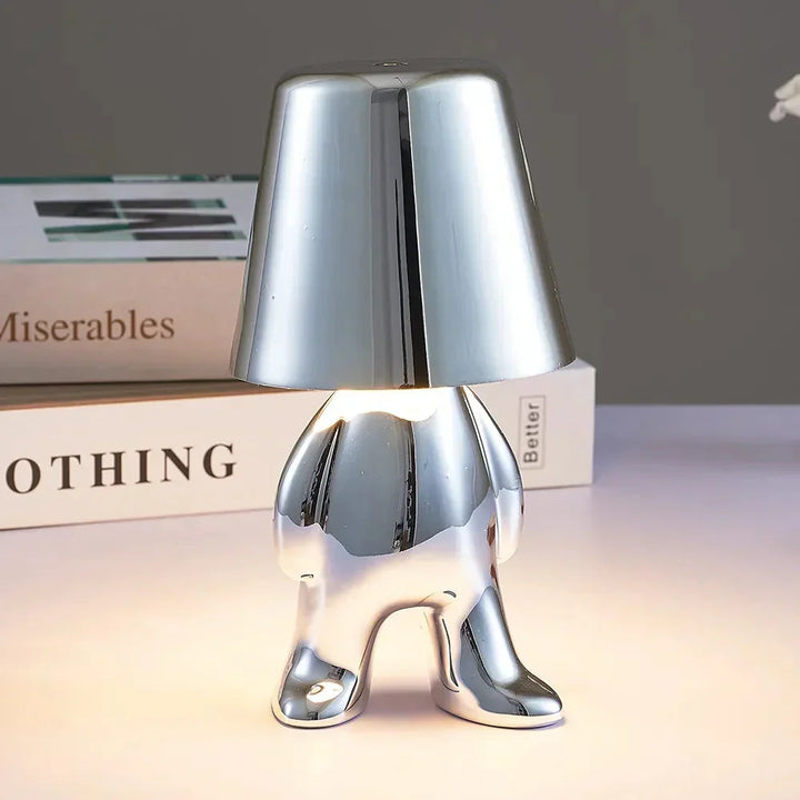 Ambient light table lamp illuminating a cozy modern bedroom