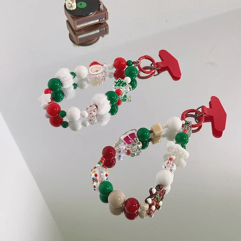 Two festive Christmas beaded keychain charms displayed together on a reflective surface