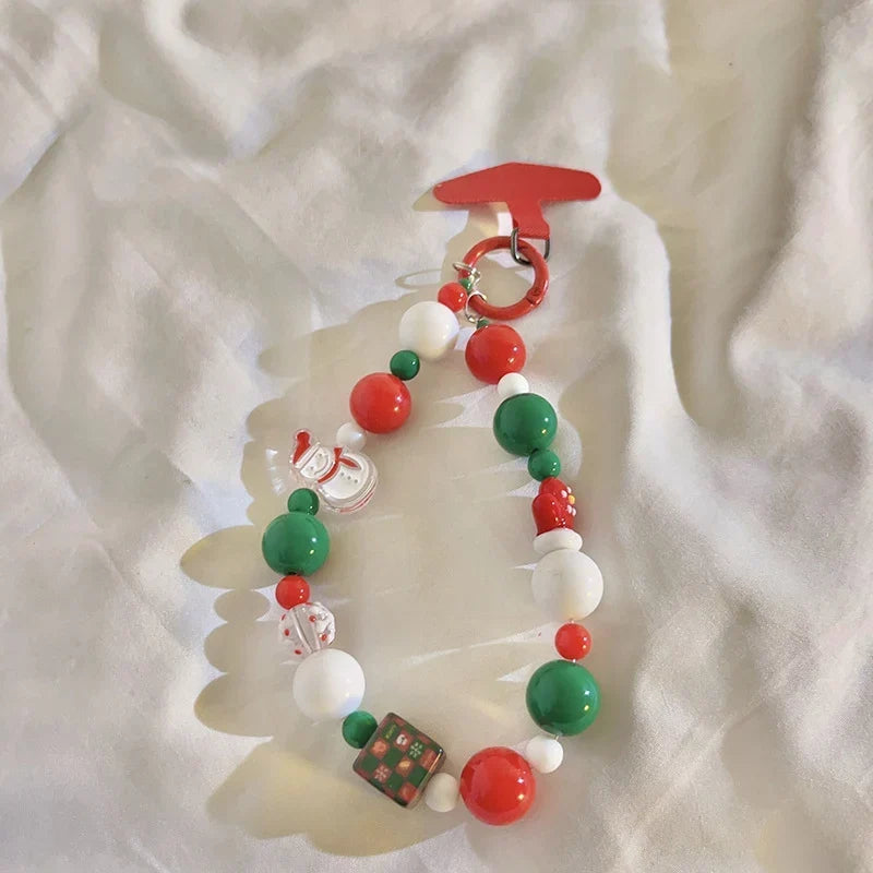 Close-up of seasonal beaded keyring and Christmas-themed bag accessory