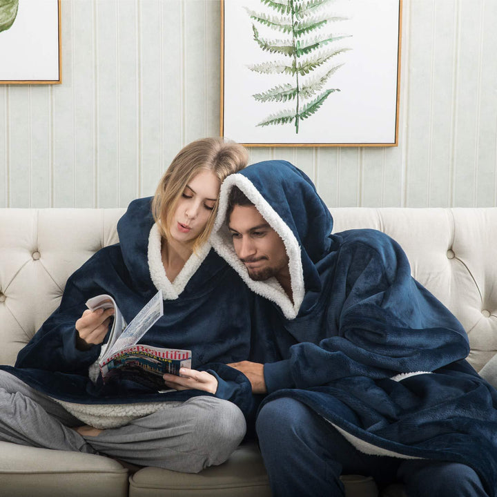 Couple relaxing on a couch together wearing matching blue thermal fleece hoodies