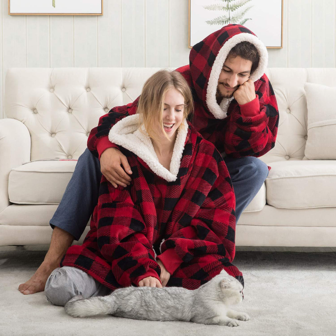 Man and woman relaxing together wearing red and black checkered thermal fleece hoodies