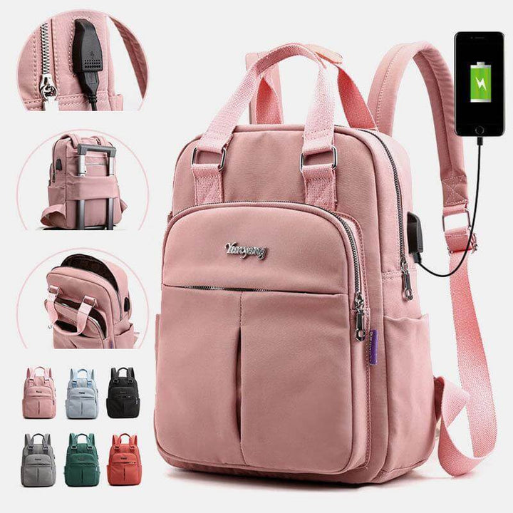 Close-up view of the pink multifunctional backpack highlighting the USB charging port and accessory pockets.