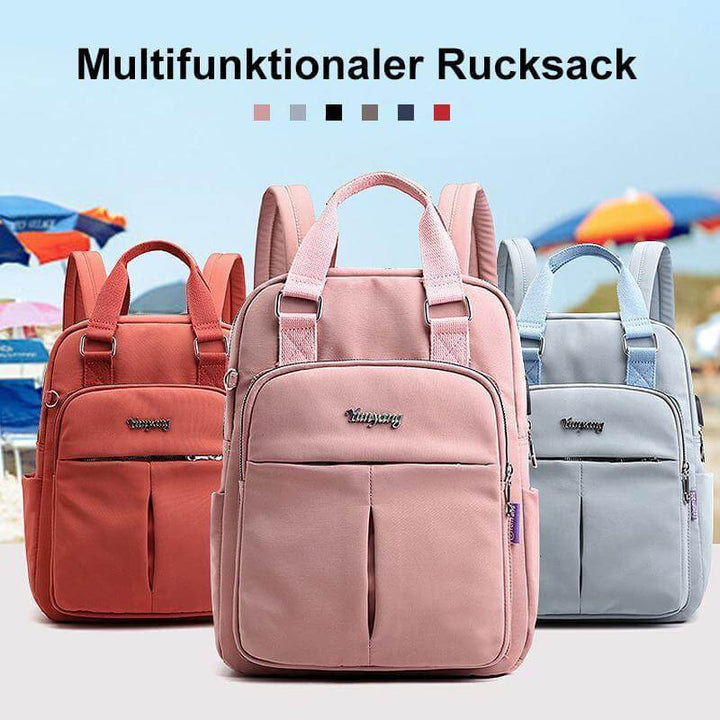 Three stylish backpacks in red, pink, and light blue posed outdoors with a scenic background.