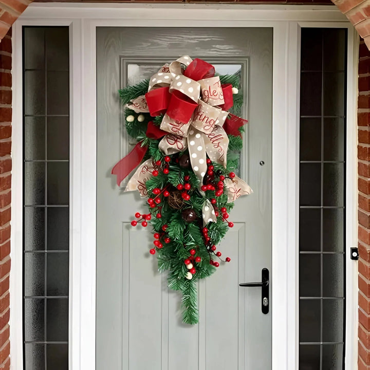 Upside down Christmas tree door swag hanging on a gray front door