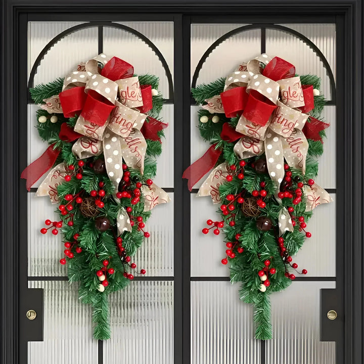 Two upside down Christmas tree door swags displayed on double doors