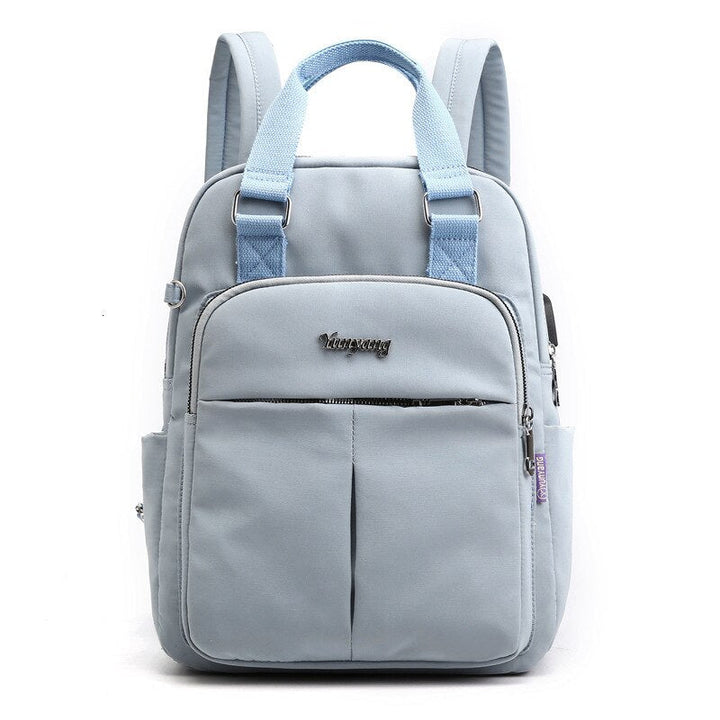 Close-up of the integrated USB charging port on the side of the commuter backpack