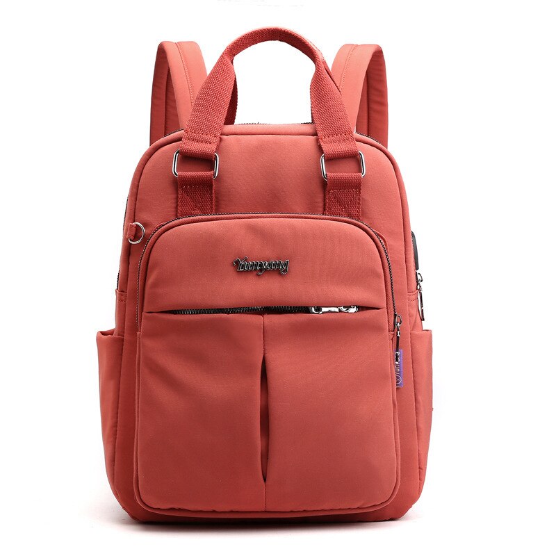 Front view of the vibrant orange multi-compartment commuter backpack