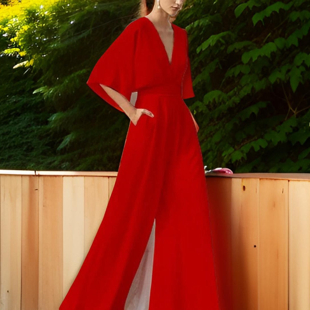 Woman wearing a vibrant red V-neck jumpsuit with three-quarter sleeves