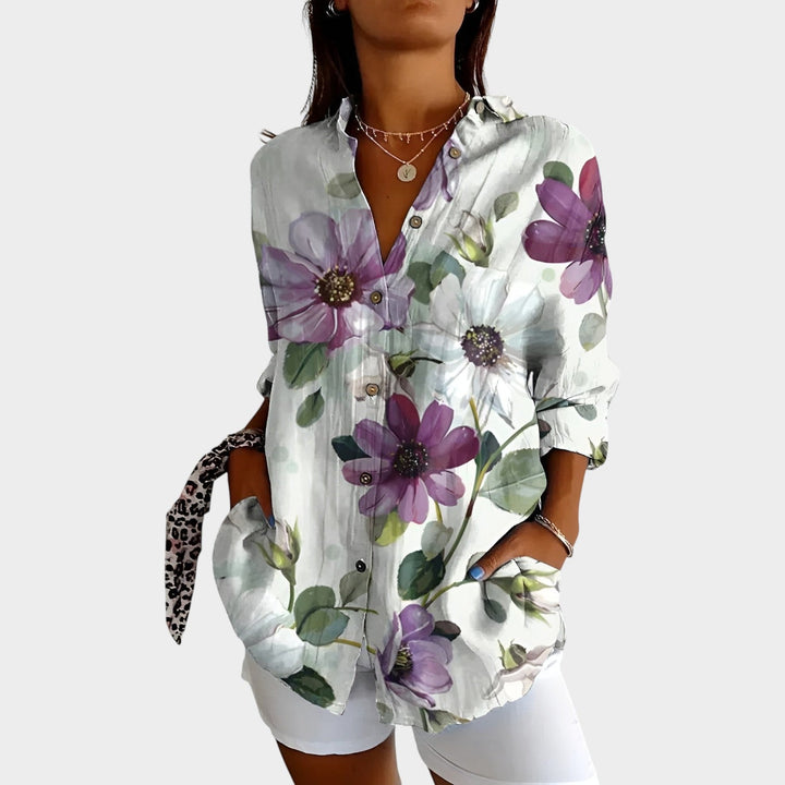Detailed shot of collar and buttons on women's chic apparel printed blouse