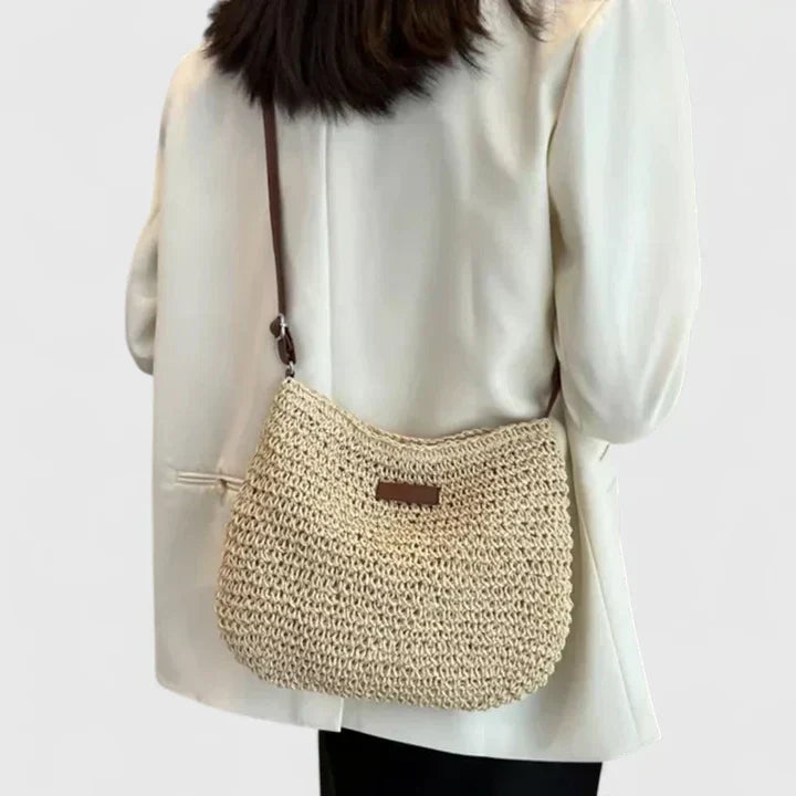 Close-up detail of natural woven straw texture and secure clasp on summer beach bag