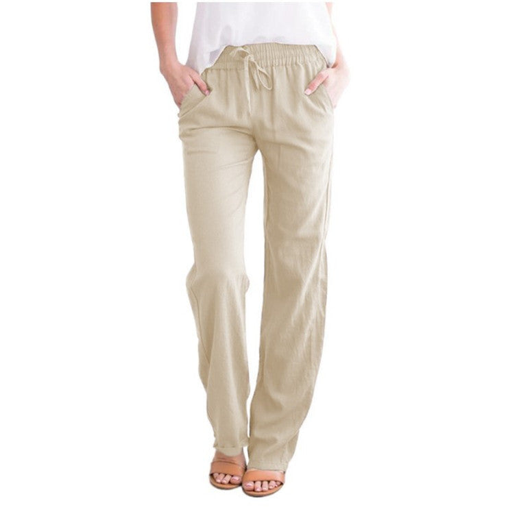Woman wearing apricot lightweight summer trousers with elastic waist and sandals