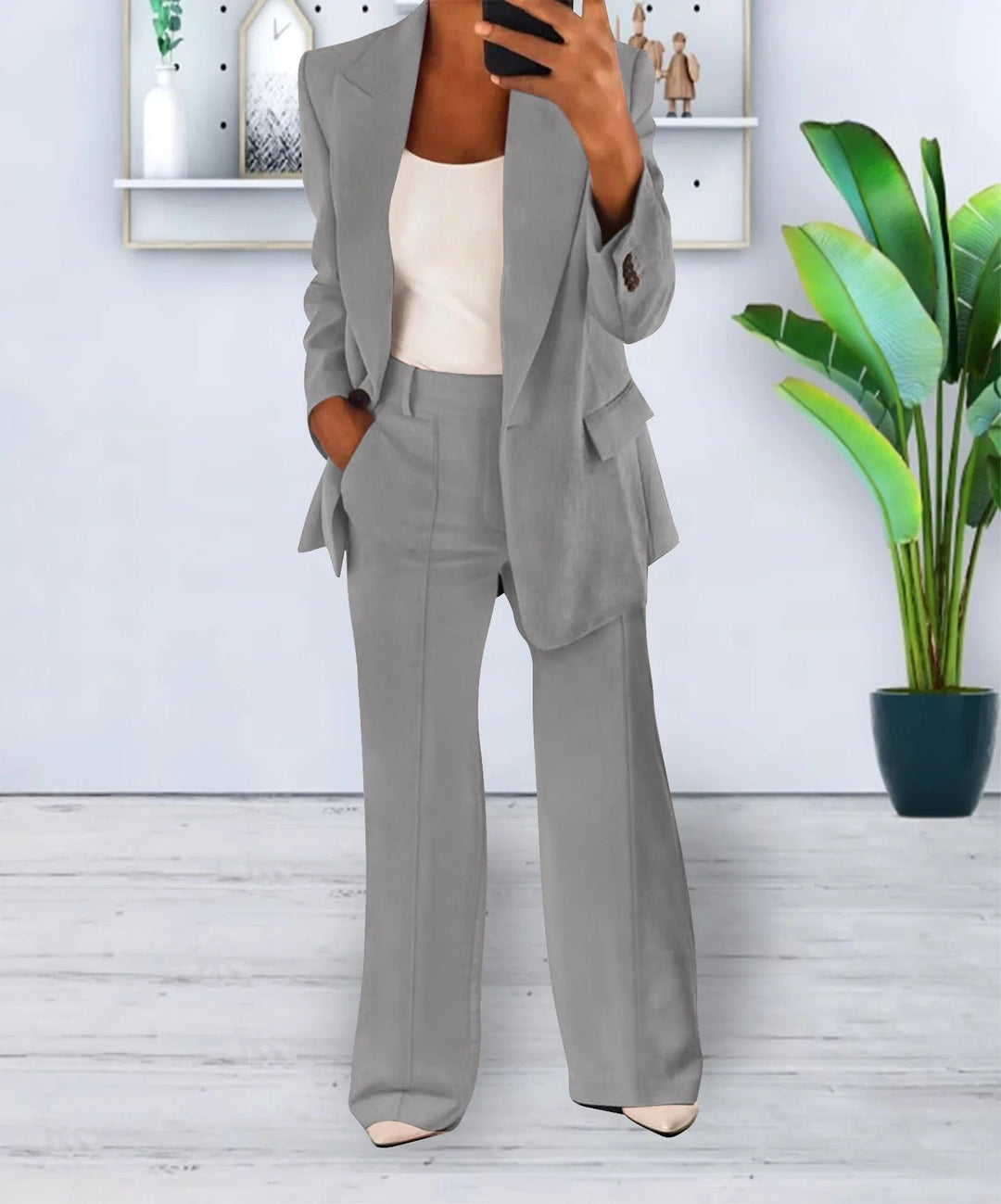 Woman wearing gray tailored blazer and wide-leg pants suit set