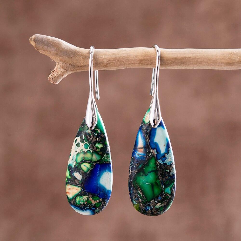 Close-up of the silver teardrop stone earrings showcasing natural green and blue patterns