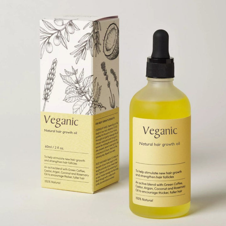 Veganic natural hair growth oil bottle next to its illustrated packaging box