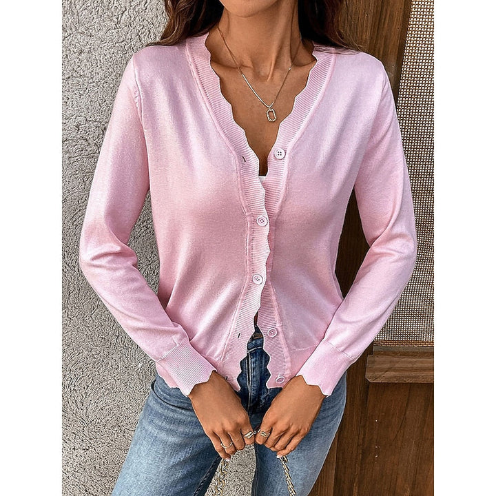 Close-up front view of the pink scalloped trim knit cardigan