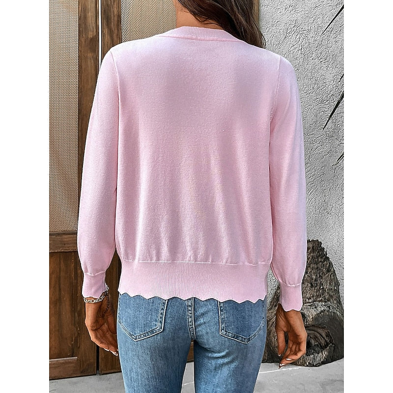 Back view of the pink knit cardigan showing the hem and fit