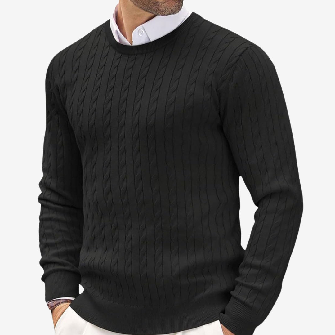 Man wearing a black crew neck cable knit sweater with textured pattern