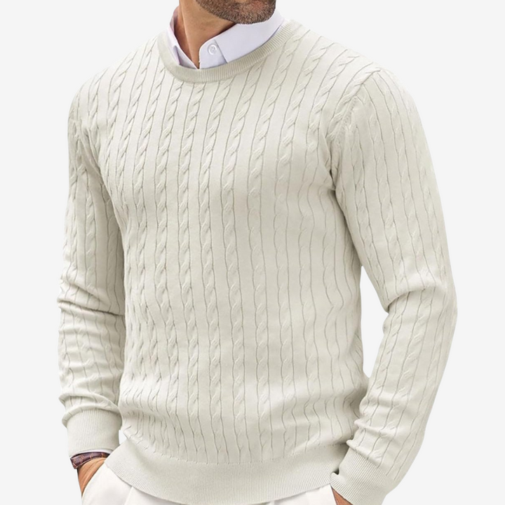 Man wearing a beige crew neck cable knit sweater with ribbed trim