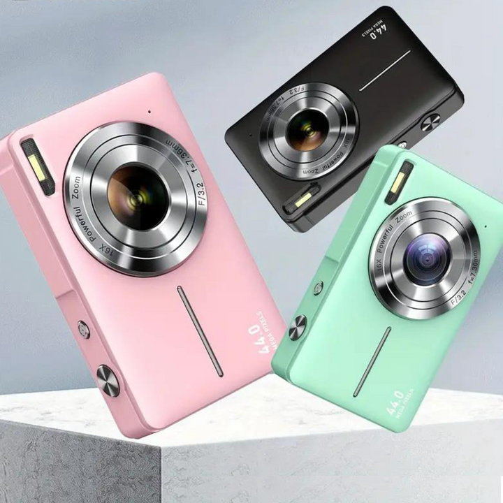 Angle view of pink, black, and green Y2K-style digital cameras