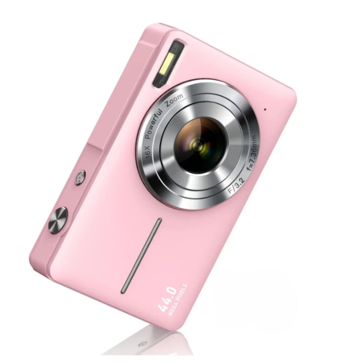Lightweight pink travel camera held in hand to show pocket size