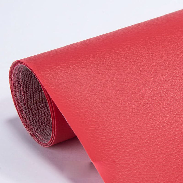 Sofa repair kit patch covering a deep scratch on a brown leather armchair