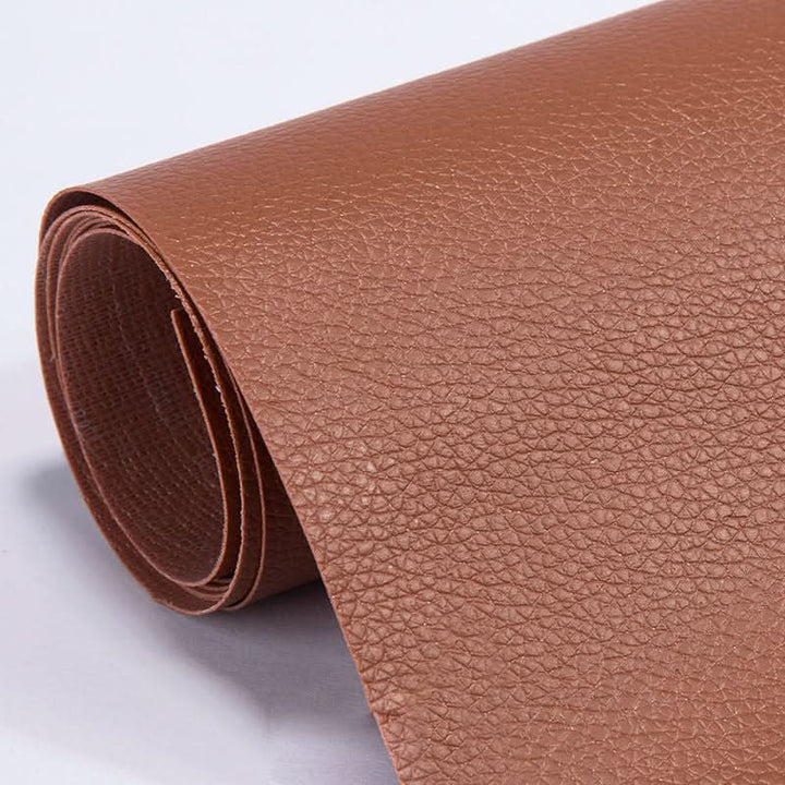 Rolled light brown self-adhesive leather repair patch showing textured surface