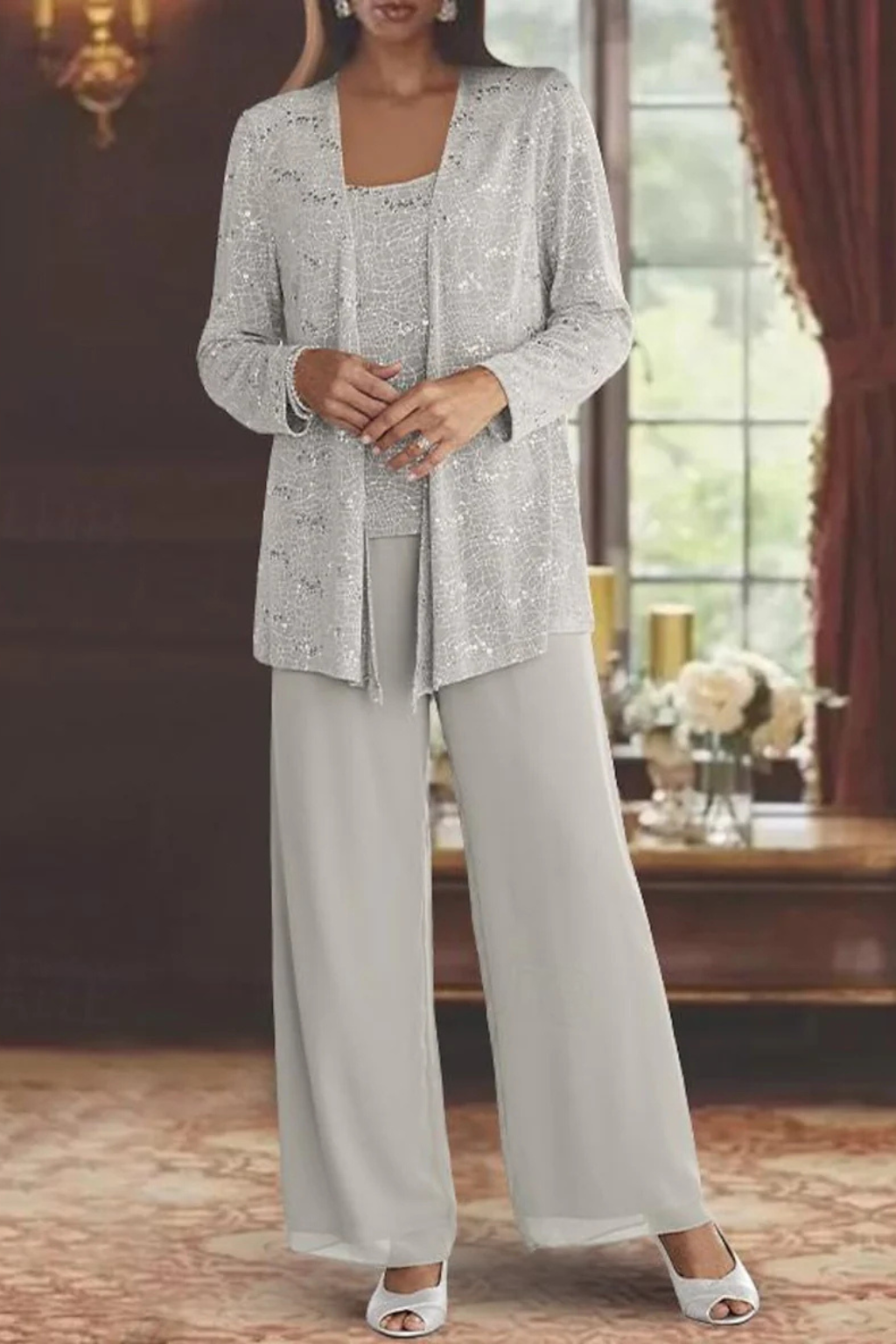 Elegant front view of the sequin jacket and trousers in a warm interior setting