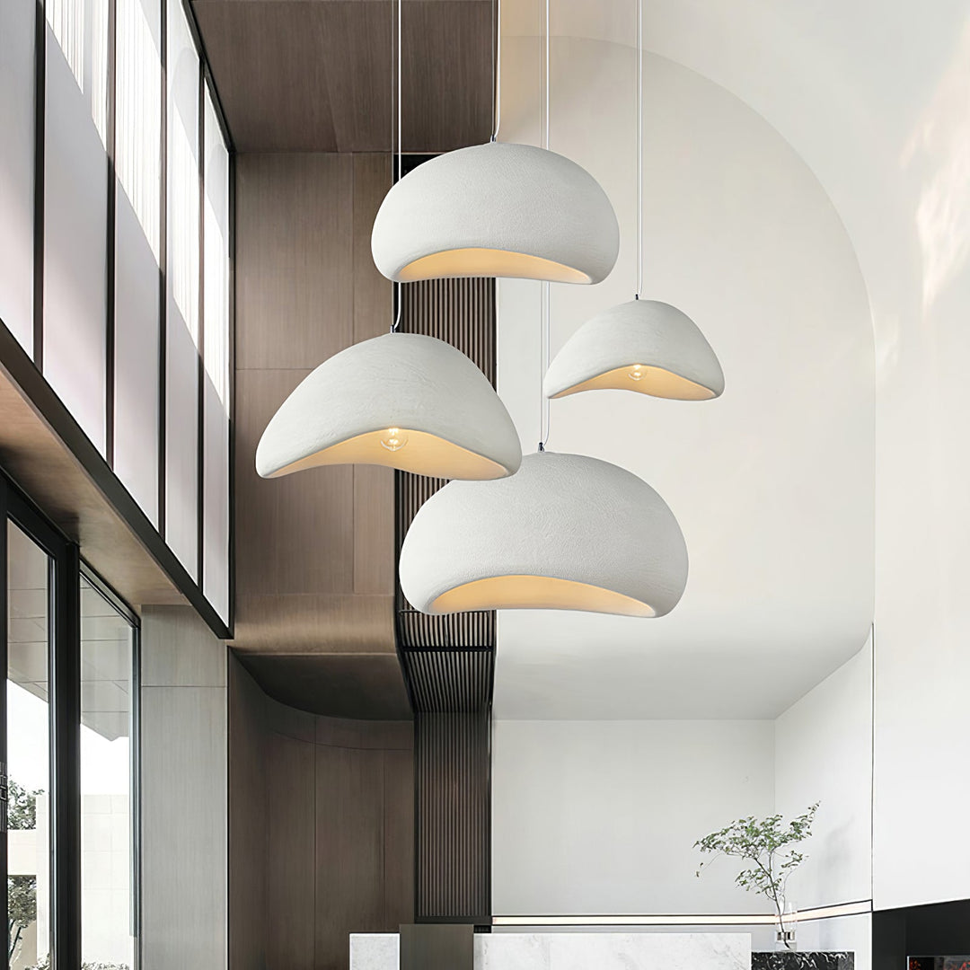 Multiple white Wabi-Sabi cocoon pendant lights hanging in a modern high-ceiling interior
