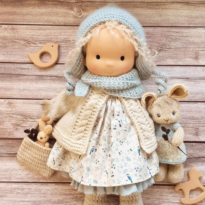 Handmade Waldorf doll showcasing soft fabric hair and natural facial features