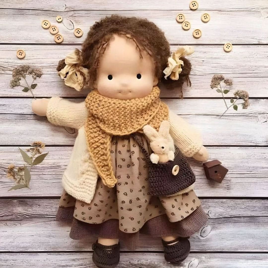 Full view of handmade Waldorf doll laid flat on a rustic wooden background with decorative elements