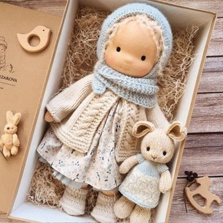 Detailed view of artisan Waldorf doll dress embroidery and fabric