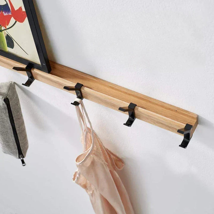Wall coat rack displaying hanging accessories in a stylish hallway setting