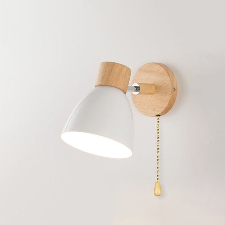 Modern white wooden cone wall lamp with pull chain switch mounted on white wall