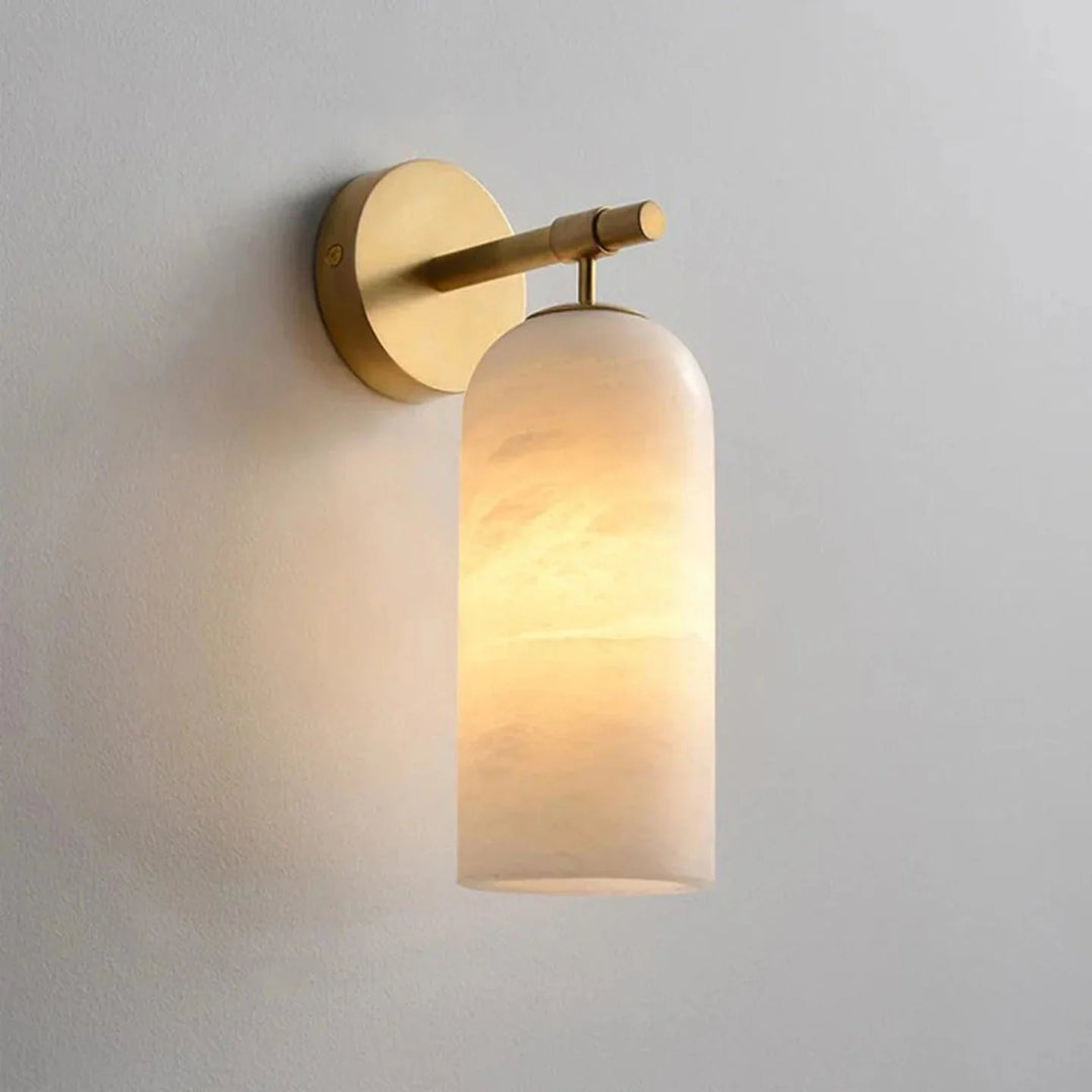 Illuminated gold wall light sconce with vertical alabaster shade
