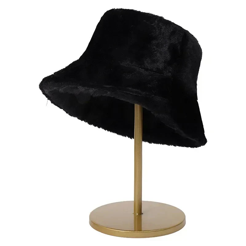 Black plush bucket hat displayed on a gold stand
