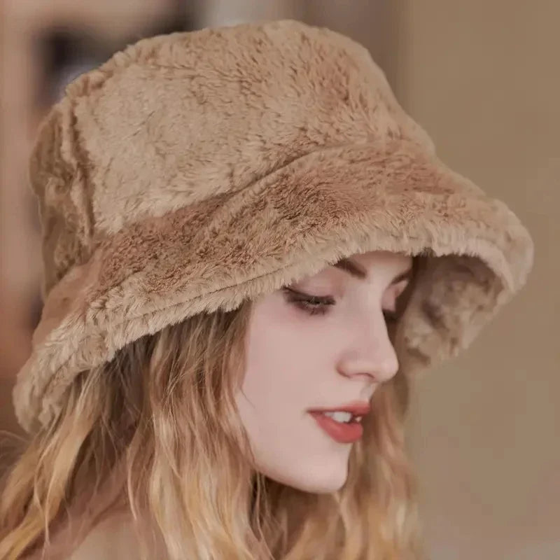 Close-up of a woman wearing a beige plush bucket hat