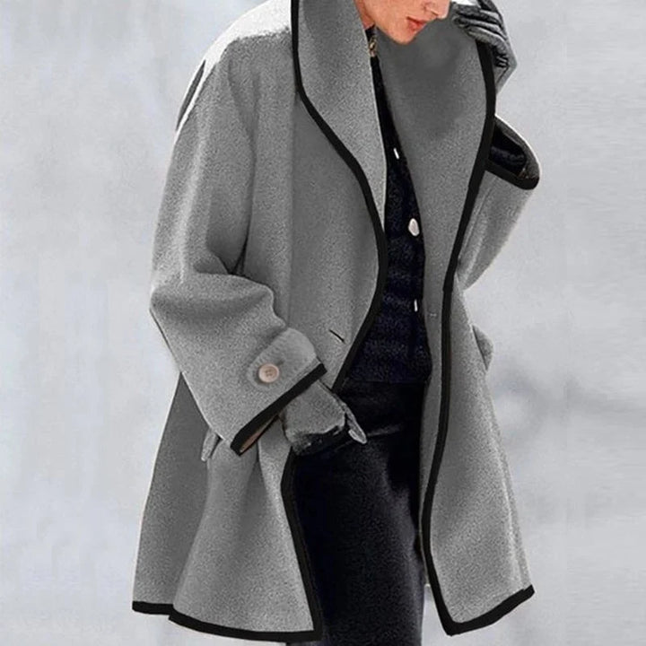 Women wearing a grey winter trench coat with deep pockets