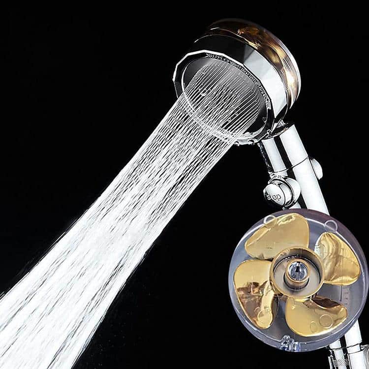 High-pressure water-saving shower head spraying water with visible turbo fan