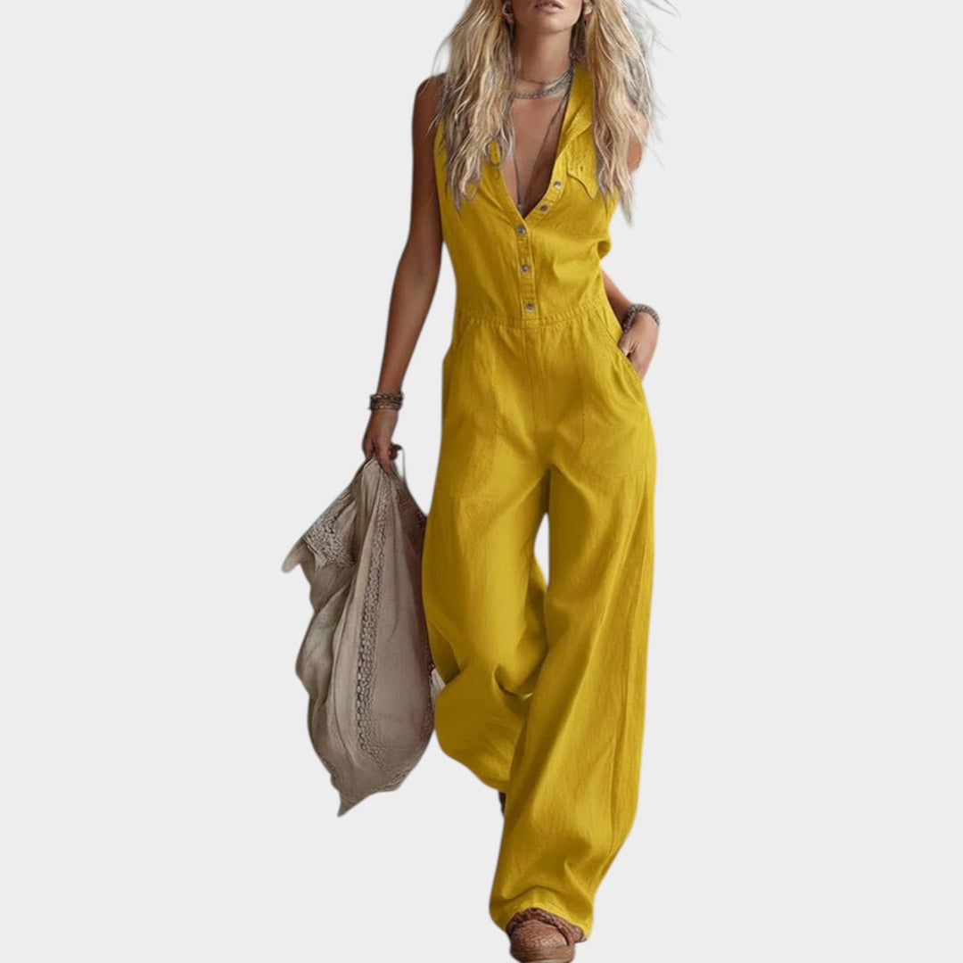Woman wearing a yellow sleeveless wide leg jumpsuit with pockets