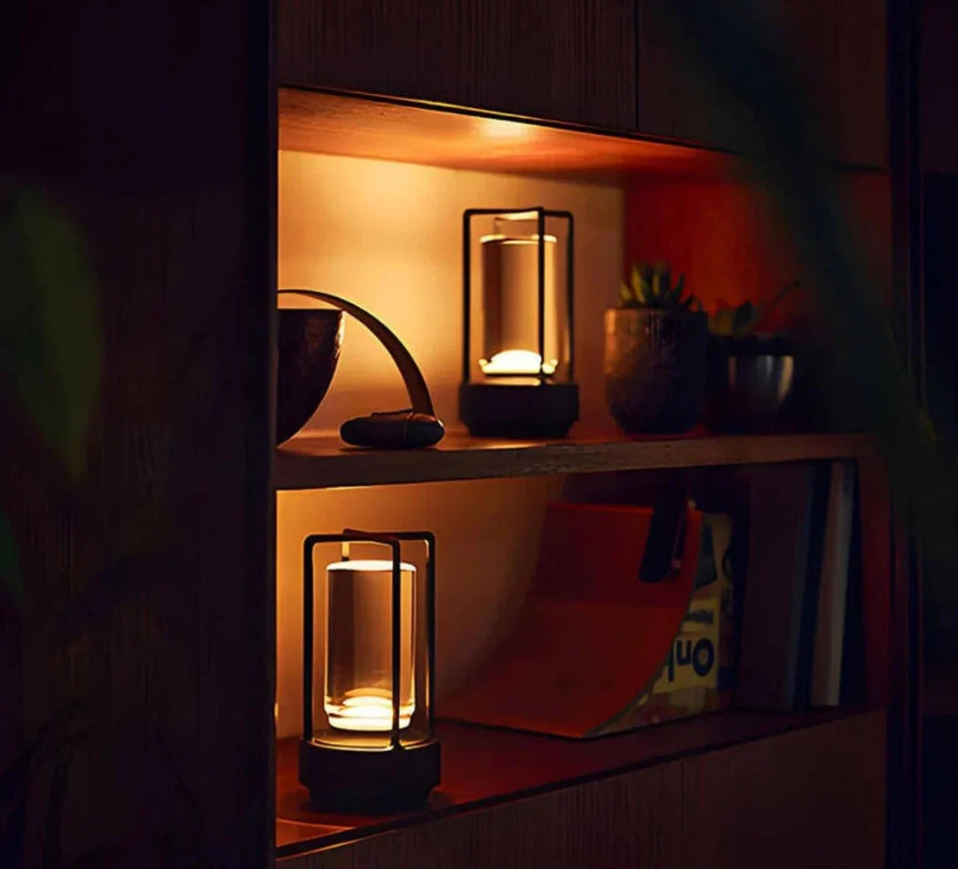 Black portable crystal table lamps illuminating a wooden shelf in a cozy room.