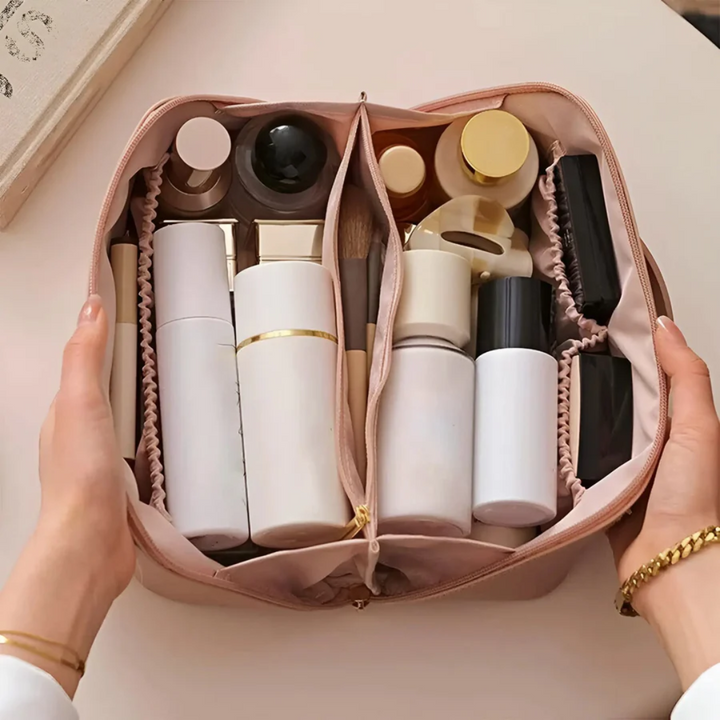 Pink cosmetic travel bag open and filled with beauty products