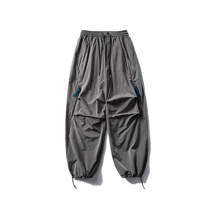 Close-up of zipper pockets and durable material on wind-resistant outdoor trekking trousers