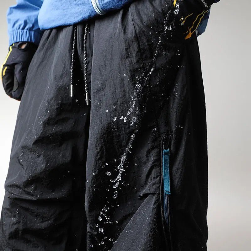 Close-up of water splashing off waterproof hiking pants fabric