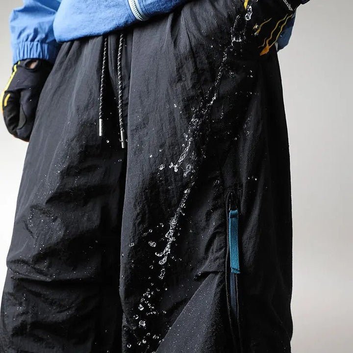 Close-up of water splashing off waterproof hiking pants fabric