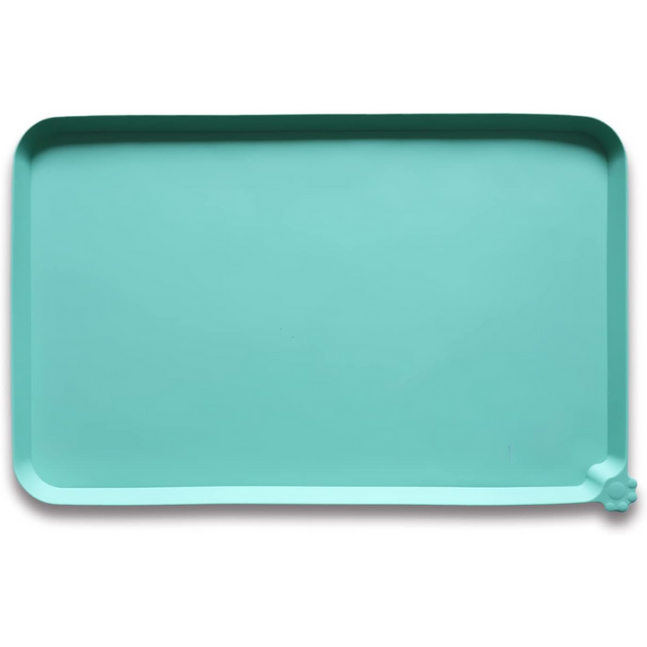 Flexible silicone pet feeding mat being wiped clean with a damp cloth