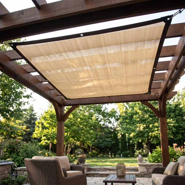 Beige waterproof shade sail installed on a wooden pergola over a patio