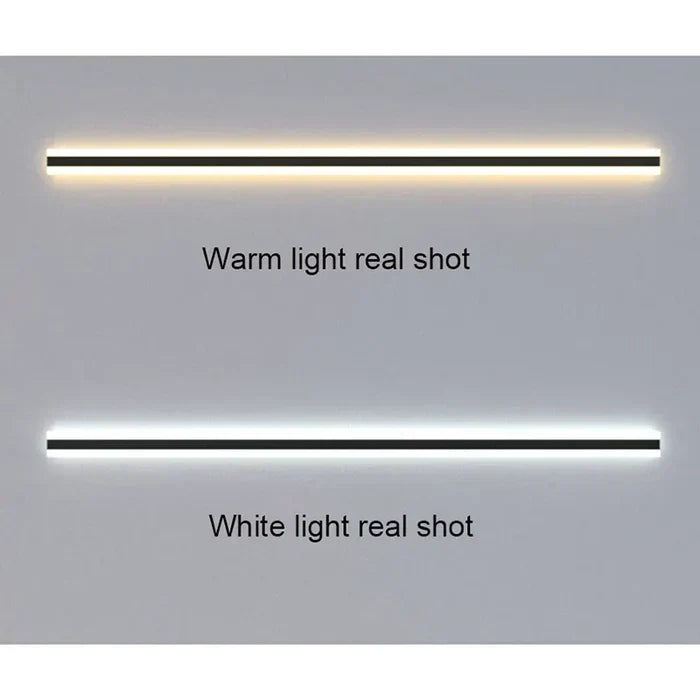 Modern outdoor wall lamp mounted on a dark exterior house facade