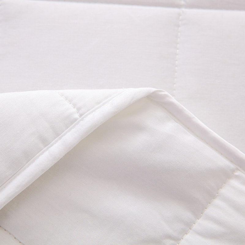 Rolled up grey gravity blanket tied with a ribbon ready for gifting