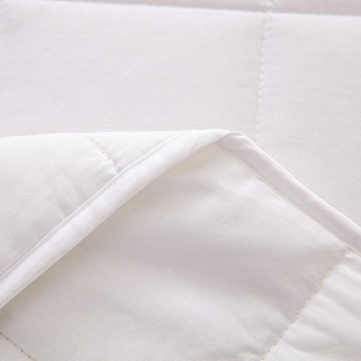 Rolled up grey gravity blanket tied with a ribbon ready for gifting