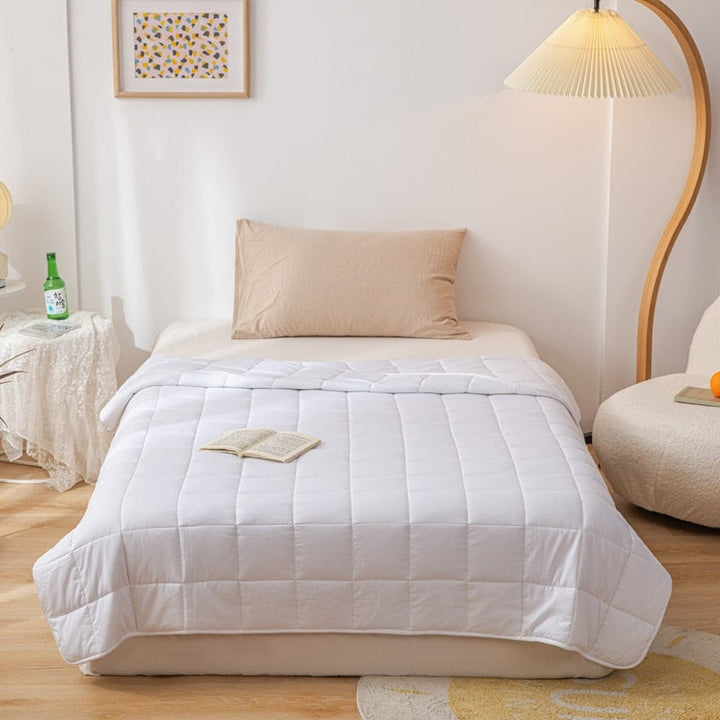 Unisex weighted blanket folded neatly showcasing soft breathable fabric for sleep